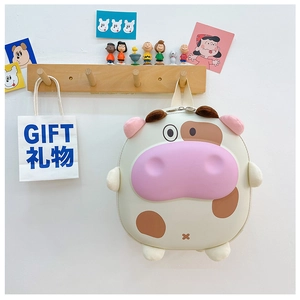 Détail du sac à dos vache pour enfant montrant les cornes en peluche et le visage