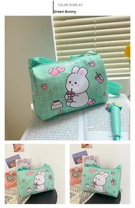 Detail of mint green cylindrical canvas bag with cute cartoon rabbit and woven strap