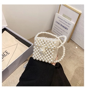 Detail of a chic girls mini pearl beaded square handbag with elegant top handle