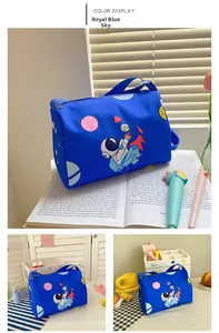 Detail of royal blue astronaut cartoon bag with rocket prints and adjustable strap