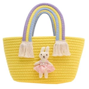 Yellow woven kids handbag with rainbow handles and a cute plush rabbit decoration