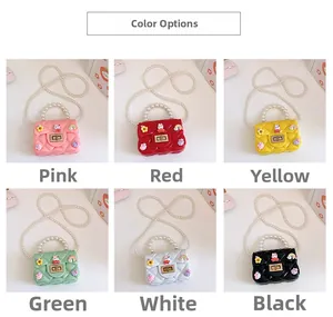 Detail showing colorful silicone jelly bags with pearl handles and cartoon charms