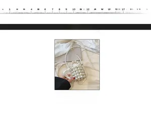 Detail view of handmade pearl woven mini bucket bag with long crossbody strap and ruler