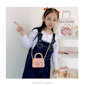 Pink jelly crossbody bag with pearl handle and cute 3D cartoon flower and rabbit charms