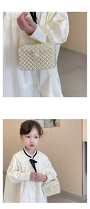 Detail of handmade beaded pearl handbag for girls showing intricate weaving and glossy finish