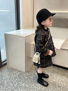 Close-up of girls vintage plaid jacket and skirt set with handmade pearl bucket bag