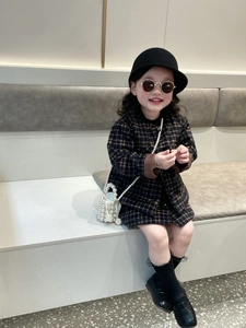 Detail of girls' plaid tweed outfit with pearl chain bag and matching beret hat
