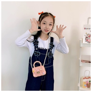 Pink mini jelly bag for girls featuring pearl handle and cute floral cartoon charms