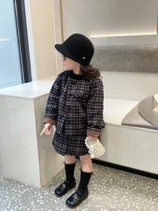 Detail view of handmade pearl bucket bag paired with a classic girls' plaid skirt suit