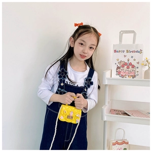 Girl's bright yellow jelly handbag with floral accents and pearl chain strap