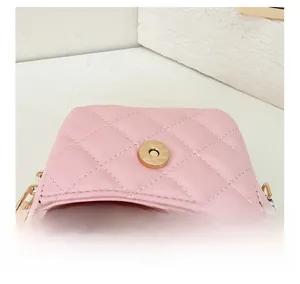 Detailed interior of a pink quilted PU mini crossbody bag with gold magnetic buckle