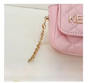 Close-up of pink quilted leather mini bag featuring gold KE hardware and chain strap detail