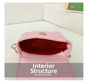 Detail view of pink quilted PU bag showing red lining and golden magnetic snap closure