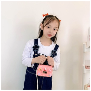 Pink jelly cross-body bag for kids with rabbit decor and pearl chain strap on model