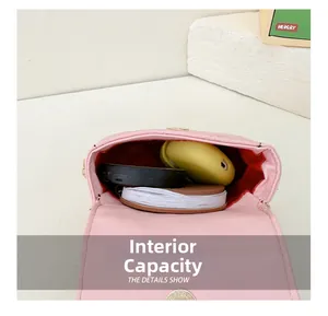 Internal view of pink quilted mini crossbody bag showing storage capacity and brown lining