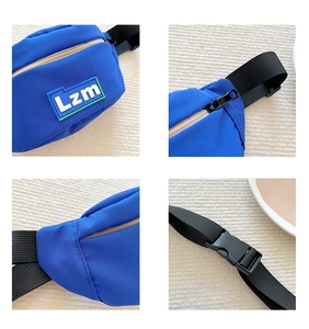 Detail view of blue kids sports fanny pack showing zippers, stitching and adjustable buckle