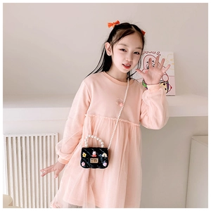 Pink girls' dress paired with a black quilted mini bag featuring colorful charms and pearls