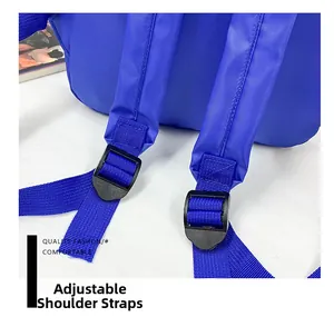 Detail of adjustable shoulder strap with durable plastic buckle on navy canvas backpack