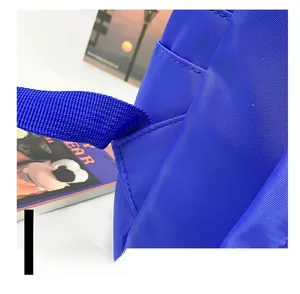Detail showing the reinforced triangular stitching on blue nylon backpack shoulder straps