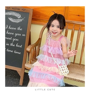 Detail of girls pink mesh cake dress with a white pearl woven bow crossbody bag