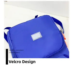 Detail of the blue canvas backpack featuring a velcro patch area for personalization