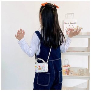 White quilted crossbody bag for girls featuring pearl handle and cute bunny charms
