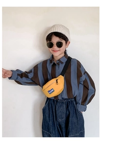 Close-up of kids yellow nylon waist bag with blue logo label and adjustable strap