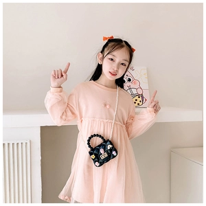 Detailed view of pink mesh dress with mini quilted bag featuring pearl handle and flower