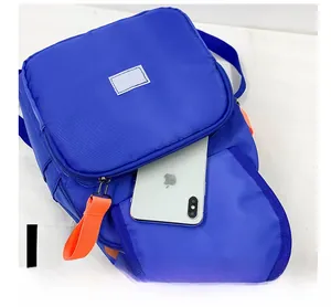 Detail shot showing the functional front zipper pocket of this blue canvas kids backpack