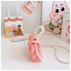 Detail of pink silicone girls' jelly bag with pearl handle and quilted texture