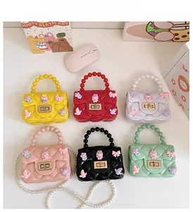 Mini borse in silicone per bambine in sei colori con trama trapuntata e manici di perle