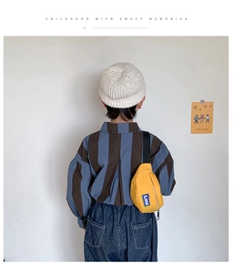 Rear view of yellow canvas kids chest bag with letter patch and striped shirt outfit