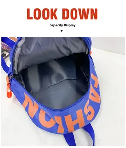 Blue nylon school bag with wide open main compartment showing large storage capacity