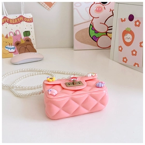 Detailed view of pink silicone jelly bag with pearl strap and cute floral charms