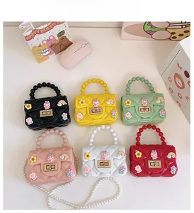 Detailed flat lay of cute mini jelly handbags with pearls in six vibrant colors