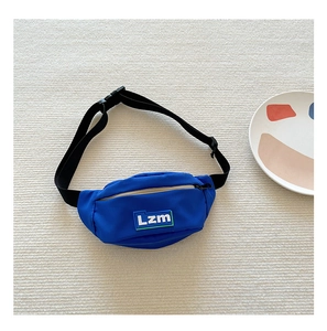 Detail view of bright blue kids fanny pack with adjustable strap and Lzm logo label