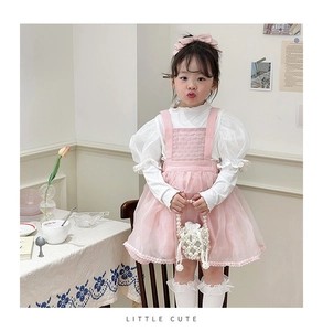Girl's pink tulle princess dress with pearl chain bag and bow headband outfit detail