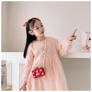 Detail of cute rabbit crossbody bag with pearl strap and cherry knit dress for girls