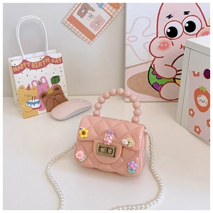 Detail of pink silicone jelly bag for girls with pearl handle and cartoon floral charms