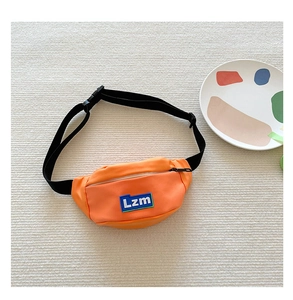 Close-up of vibrant orange kids' waist bag with Lzm logo and adjustable black strap