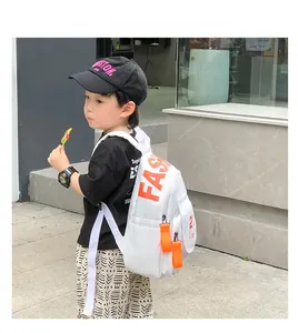 Detail view of white kids backpack with bright orange FASH print and durable side pockets