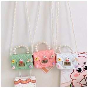 Three mini silicone jelly bags with pearl handles and cute charms for young girls