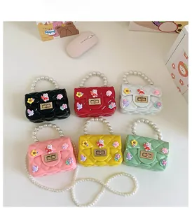 Flat lay of colorful quilted mini purses with pearl handles and cute rabbit charms