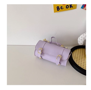 Détail du sac cylindrique violet pour fille avec boucles dorées et texture cuir souple