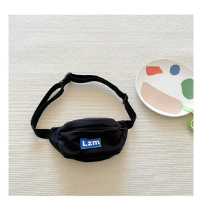 Detail of black canvas waist bag showing Lzm letter patch and adjustable strap
