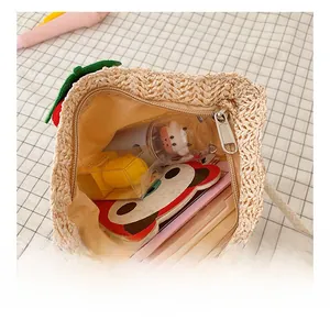 Detail view of woven straw bag interior with zipper and small toy accessories