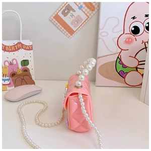 Side view of pink silicone rabbit purse with pearl handles and floral accents for girls