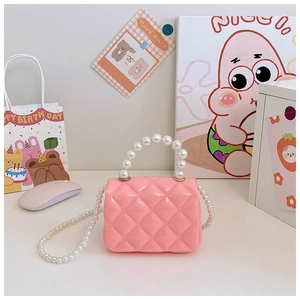 Detail of pink quilted jelly bag with pearl handle and shoulder chain for girls