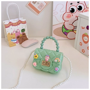 Detail of mint green mini jelly bag with pearl handle and cute floral 3D charms
