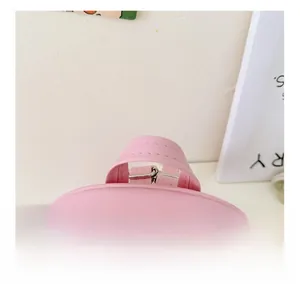 Detailed close-up of the reinforced pink PU leather top handle and nylon zipper track